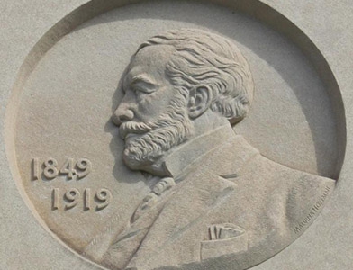 limestone relief sculpture of Henry Clay Frick profile on exterior of Frick Fine Arts building