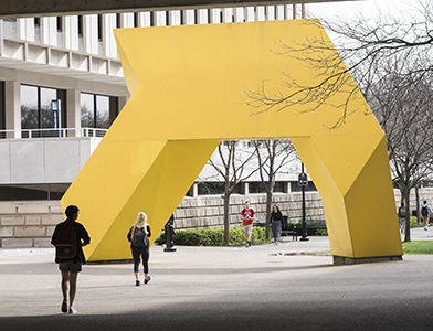 Painted yellow steel sculpture outside Posvar Hall, Light Up by Tony Smith